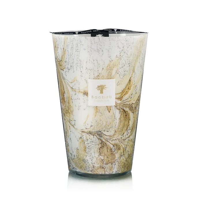 Hand blown glass candle with a visible brand label on a white background