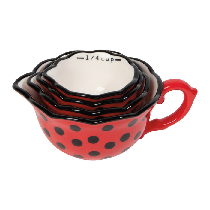 Set of red polka dot measuring cups on a white background