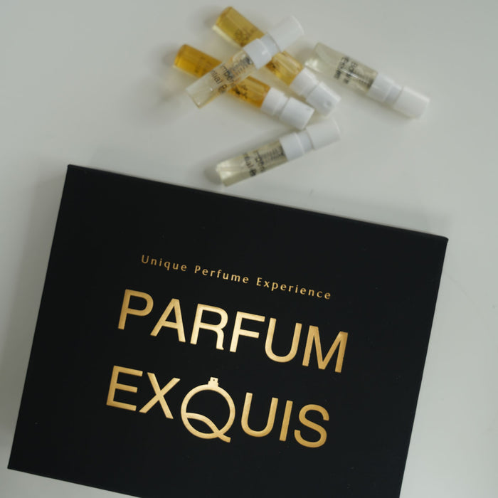 Black box with 'Parfum Exquis' branding and small perfume bottles on a white background