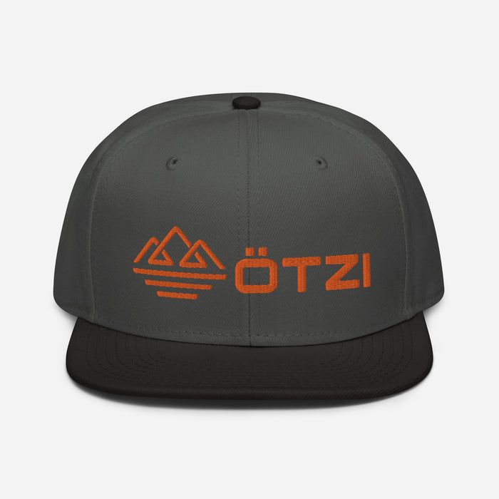 Gray and black snapback hat with orange Ötzi logo and mountain design on the front