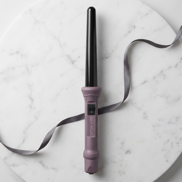 The Olla Bella 1" Ceramic Curling Iron in Plum Metallic with a gray ribbon displayed on a white marble background.
