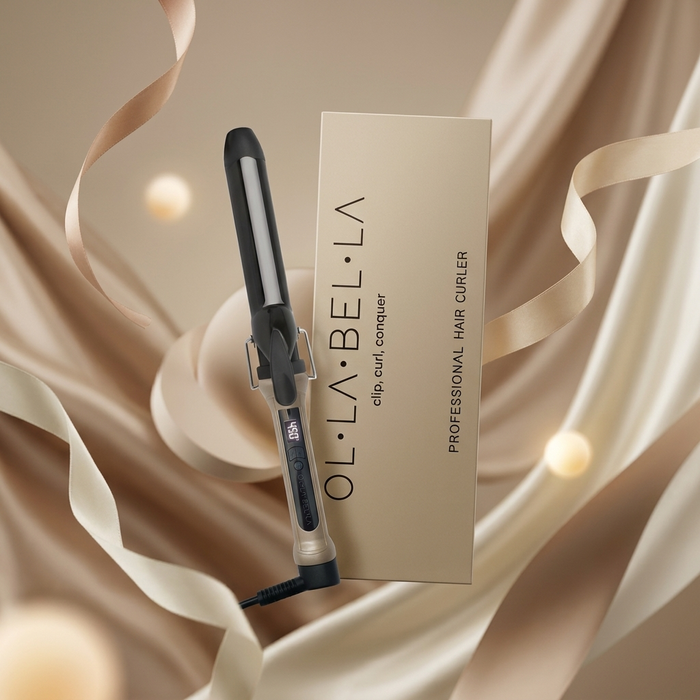 The Olla Bella 1.25" Ceramic Digital Curling Iron and box shown on a background with beige and gold ribbons