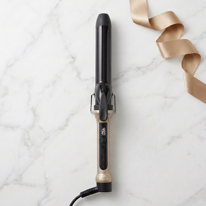 The Olla Bella 1.25" Ceramic Digital Curling Iron shown on a white marble background with a gold ribbon.