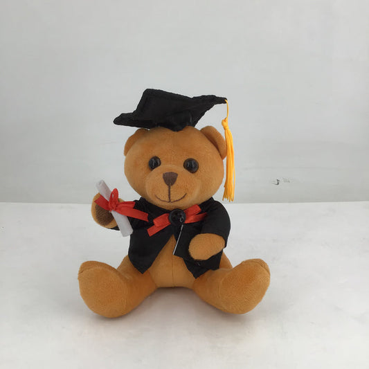 Graduation-themed teddy bear with a cap and diploma on a white background
