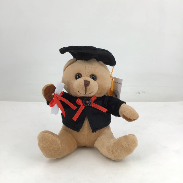 Plush teddy bear in graduation attire with a cap and gown on a white background
