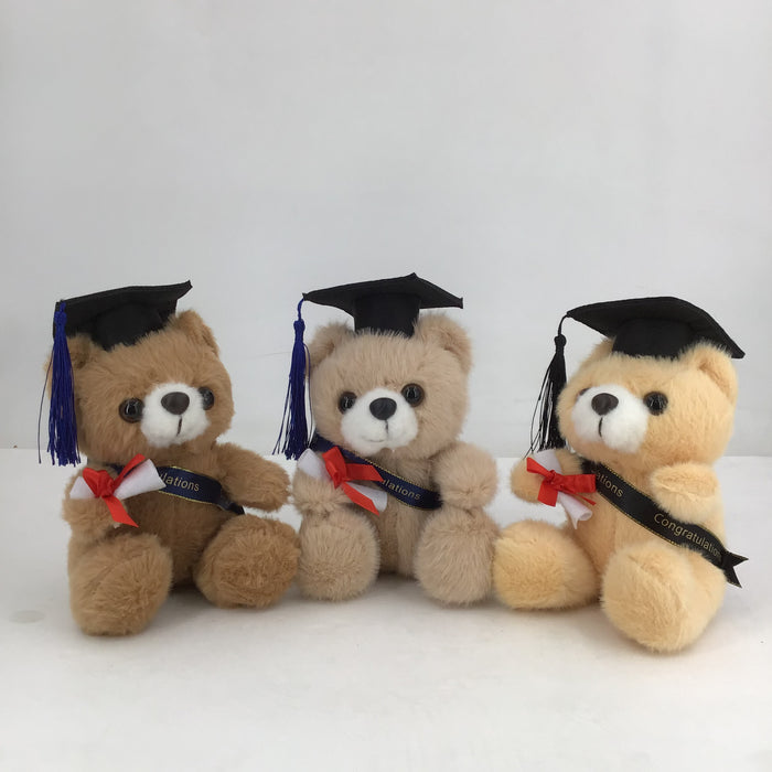 Three teddy bears wearing graduation caps and gowns on a white background