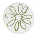 A round white plate featuring a hand-painted green floral or daisy-like pattern in the center, shown against a clean white background.