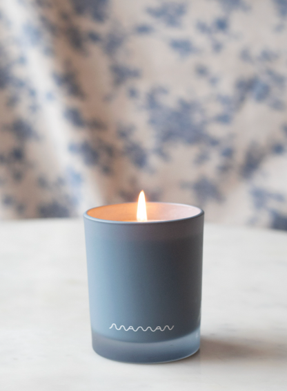 Blue Apotheke candle with white “Maman” logo.