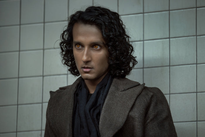 Armand with amber eyes in a grey coat — The Vampire Lestat x AMC, Interview with the Vampire Season 3
