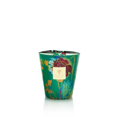 Decorative candle in a green container with floral design on a white background