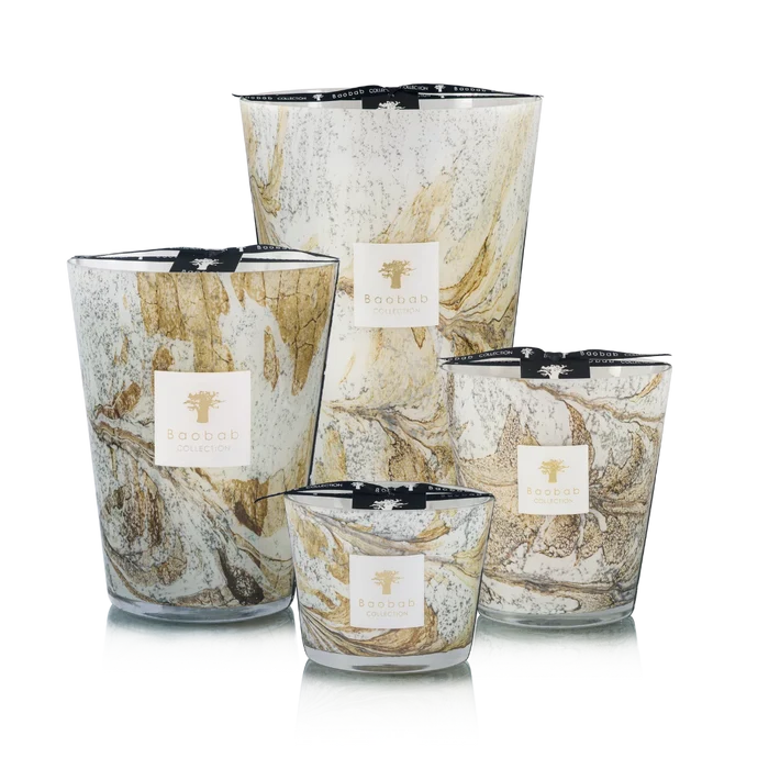 Set of four hand blown glass candles on a white background