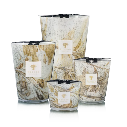 Set of four hand blown glass candles on a white background