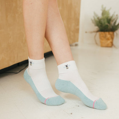 Quarter-length compression socks with a white and light blue design, featuring a bee graphic on the cuff.
