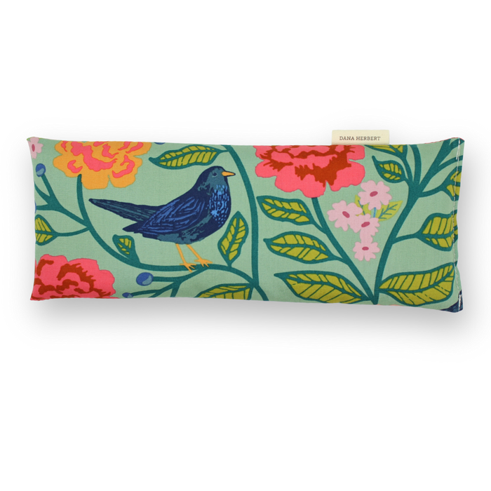 Pillow with bird and floral pattern on a white background
