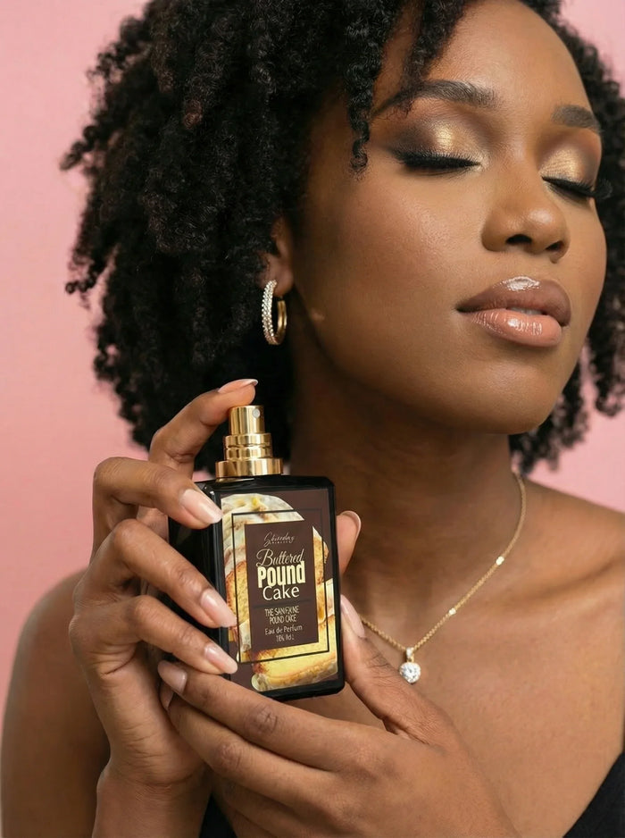 Woman with gold eye makeup and jewelry holding Buttered Pound Cake perfume bottle