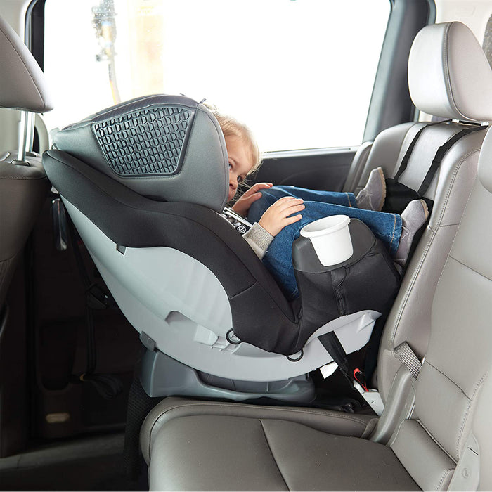 A young child sits in a rear-facing seat with a Nuby Car Seat Protector with Storage Pouch, secured by LATCH. The protector has a non-skid back and storage pouch, while the car features gray upholstery and the seat includes a cup holder.