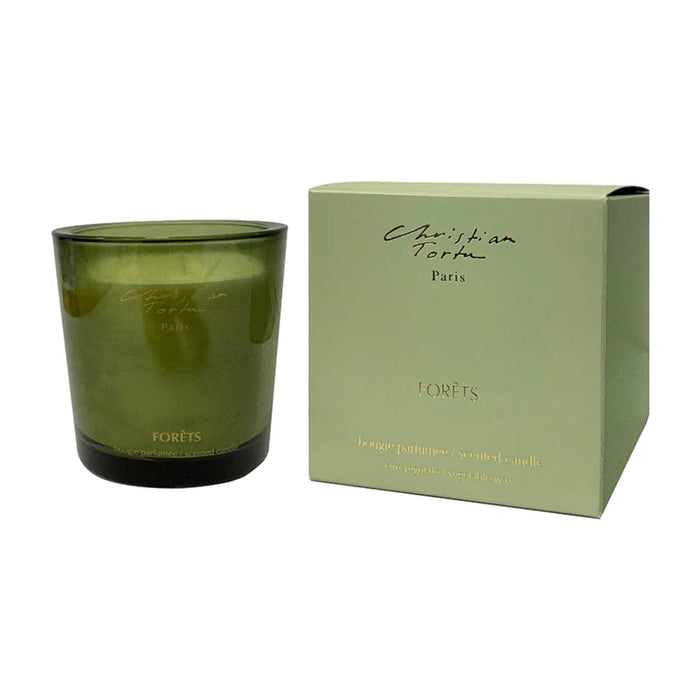 Green candle with packaging featuring 'Christian Tortu' branding on a white background
