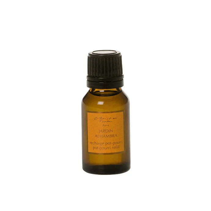 Small amber glass bottle with a black cap on a white background
