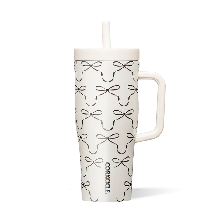 White tumbler with black bow pattern on a white background