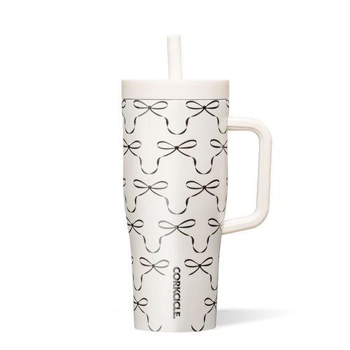 White tumbler with black bow pattern on a white background