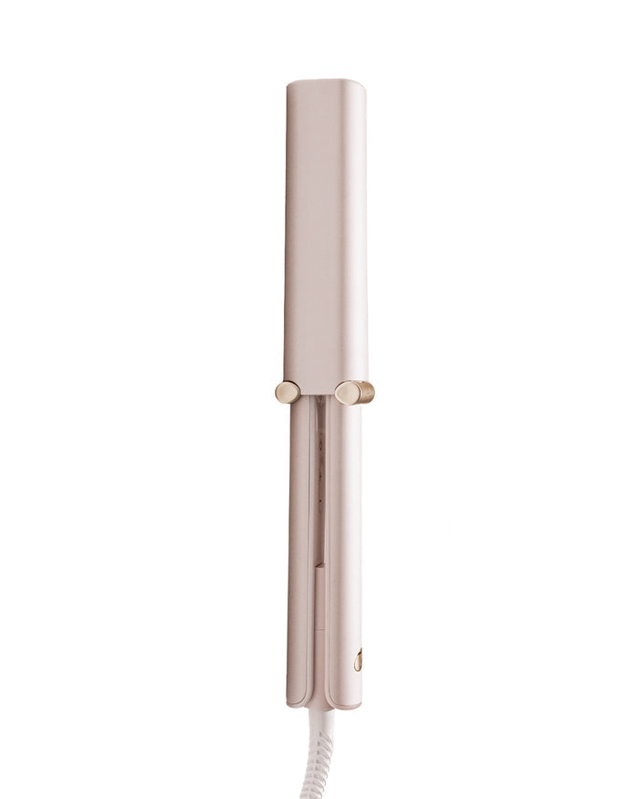 Light pink hair straightener on a white background