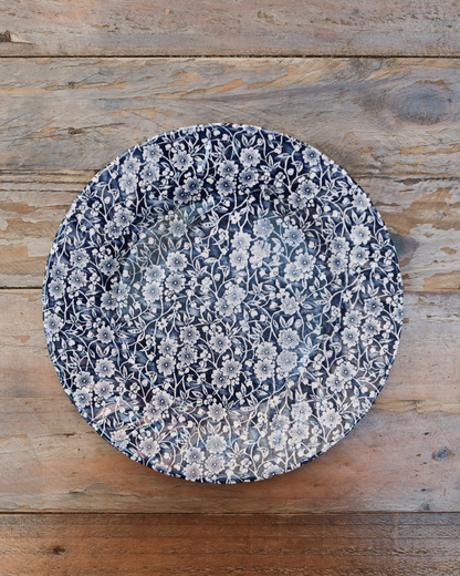maman dinner plate — white floral pattern on blue background