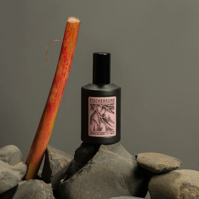 Fischersund 8 Room Spray bottle on rocks with a rhubarb stalk