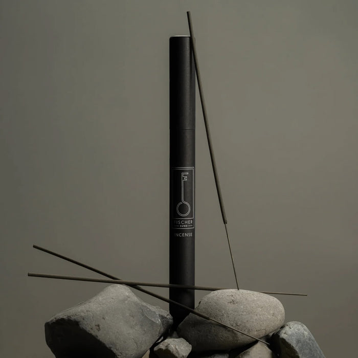 Black Fischersund incense stick tube with incense sticks on a gray background