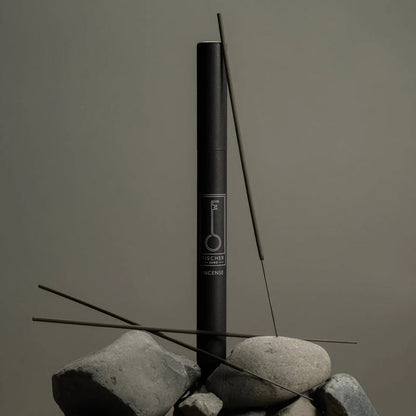 Black Fischersund incense stick tube with incense sticks on a gray background