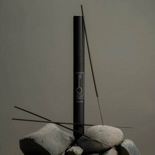 Black Fischersund incense stick tube with incense sticks on a gray background