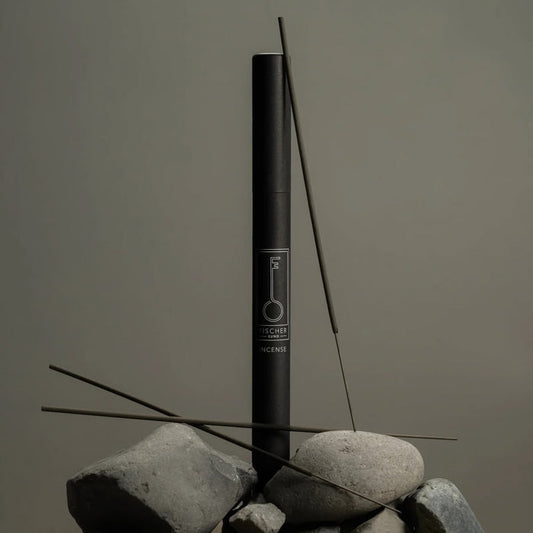 Black Fischersund incense stick tube with incense sticks on a gray background
