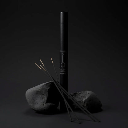 Black incense stick tube by Fischersund with incense sticks on a dark background