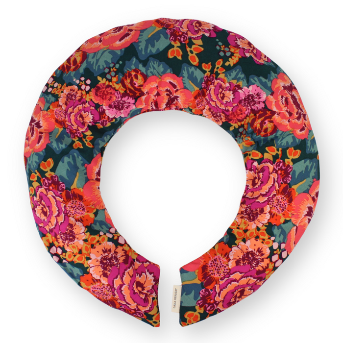 A neck pillow with a vibrant floral pattern in shades of pink, orange, and teal on a white background.