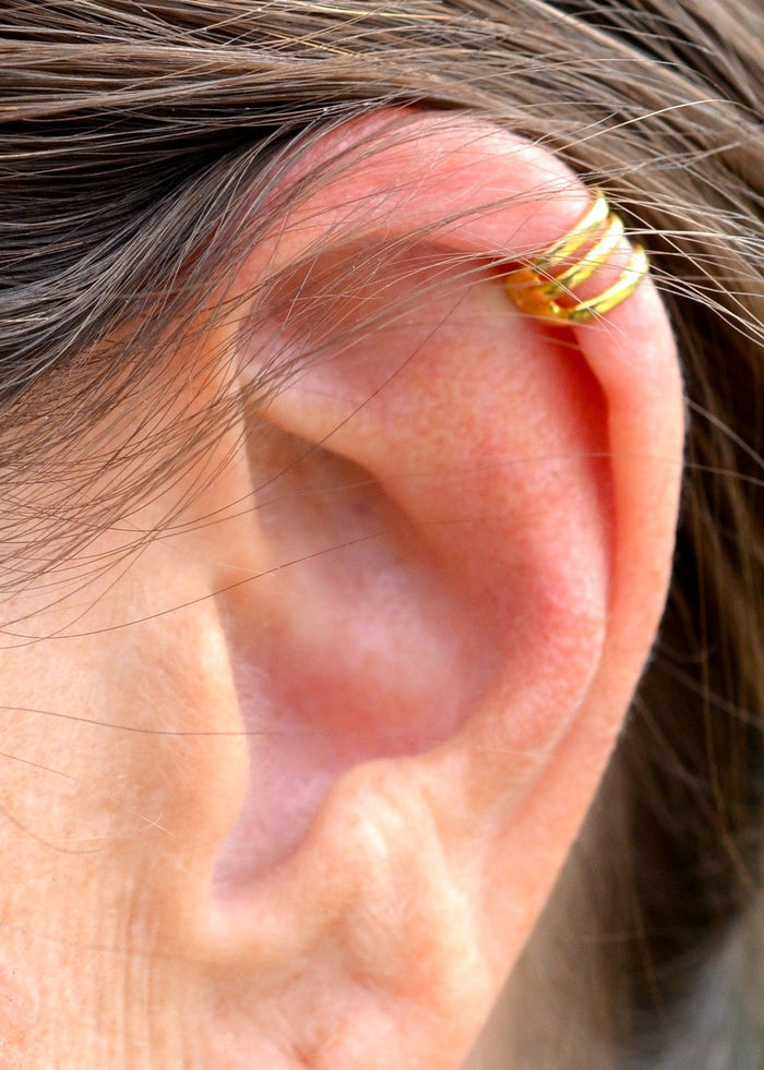 Model wearing gold mini ear cuff, non-piercing spiral wire boho ear jewelry, close-up side view
