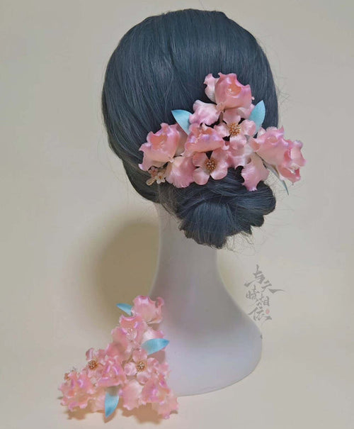 Handmade Ronghua pink iris hairpin cluster in mulberry silk velvet worn in low bun on mannequin head