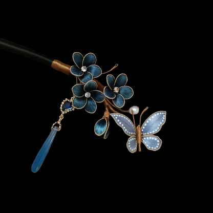 Close-up of blue silk velvet plum blossoms and butterfly details on traditional Chinese Ronghua hairpin