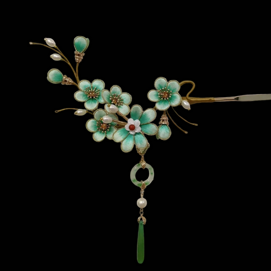 Close-up of turquoise silk velvet plum blossoms with gold details and jade tassel on Ronghua hairpin