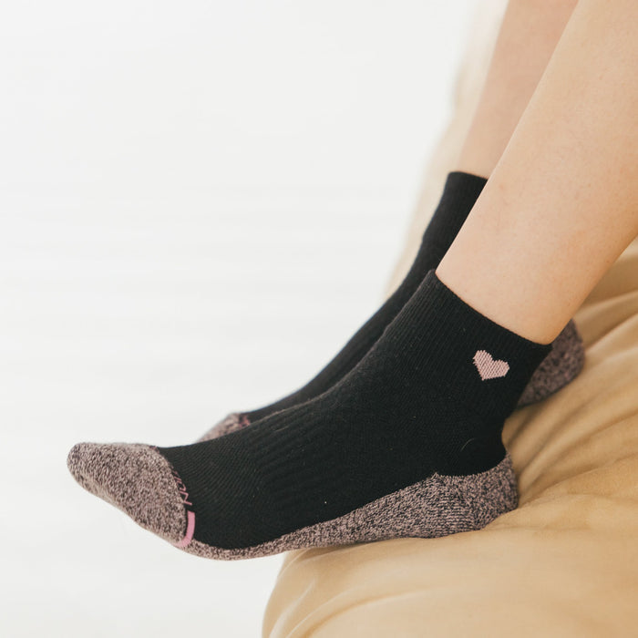 Black quarter compression socks with a pink heart design and a contrasting gray toe and heel.
