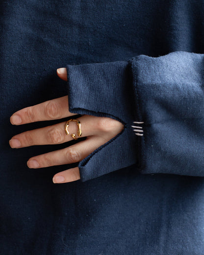 A navy blue sweatshirt with white lines details on the sleeve.