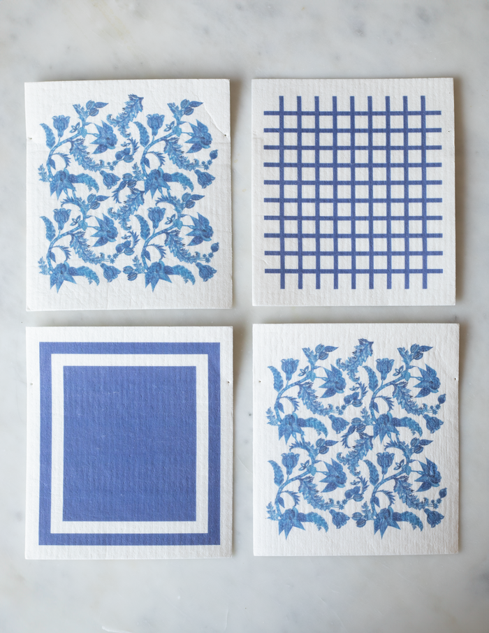 Pack of 4 reusable dishcloths: 2 with blue-and-white floral patterns, 1 with a blue square pattern, and 1 with blue grid pattern.