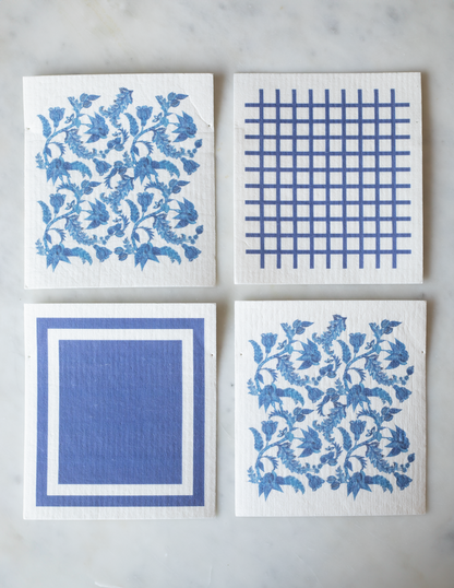 Pack of 4 reusable dishcloths: 2 with blue-and-white floral patterns, 1 with a blue square pattern, and 1 with blue grid pattern.