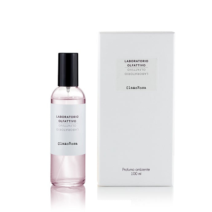A ClamoRosa room spray bottle with a white label and pink liquid visible inside, accompanied by its packaging box.