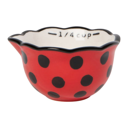 Red polka dot measuring bowl with black text on a white background