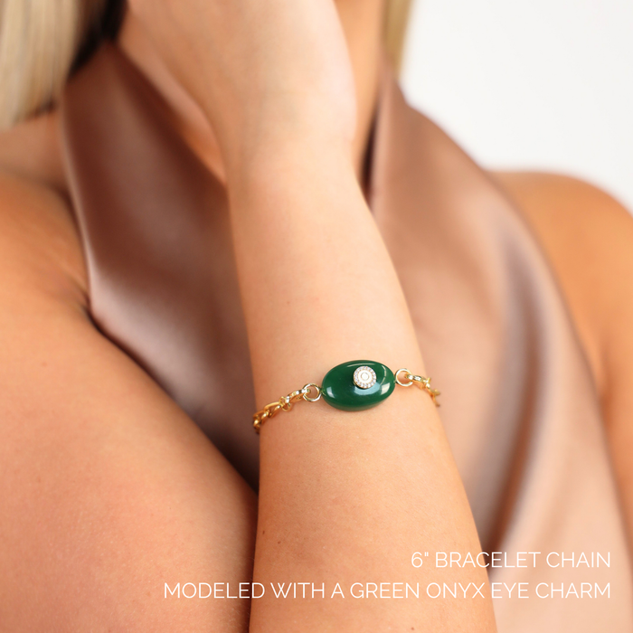 Link Chain Bracelet featuring a green onyx eye charm, modeled elegantly on a wrist.