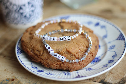 maman x Little Words Project "boy mom" and "girl mom" bracelets on a maman cookie.