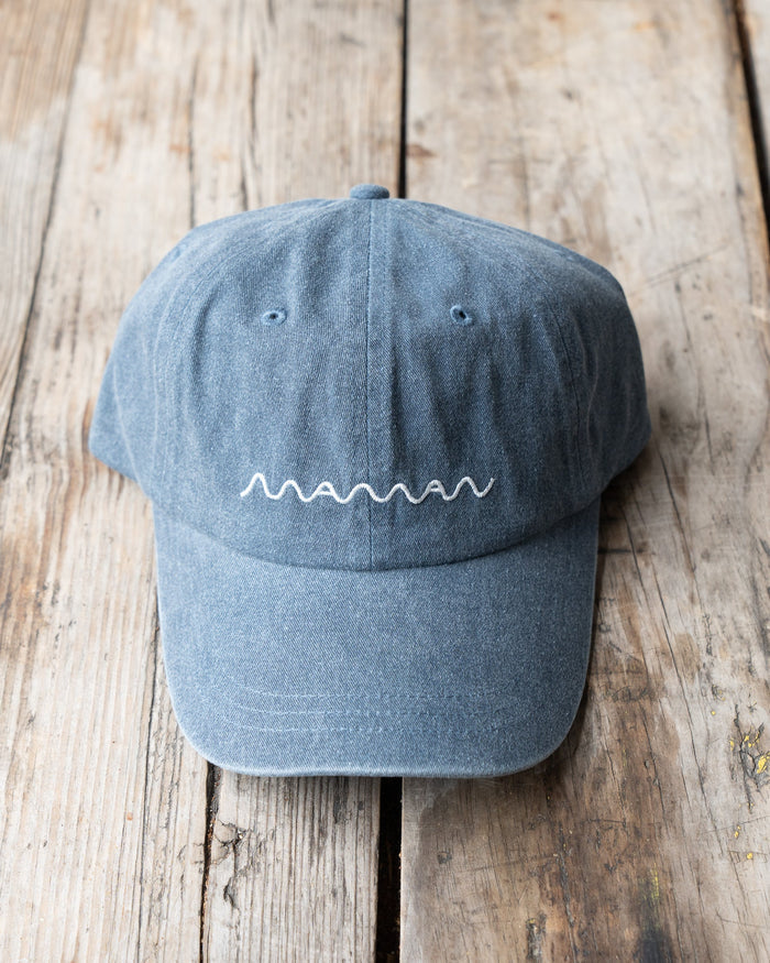 A blue denim baseball cap with the 'maman' logo embroidered on the front.
