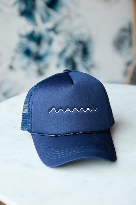 Navy blue trucker hat with white "maman" logo embroidered and a mesh back.