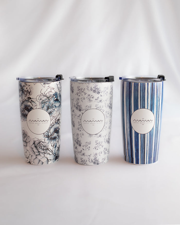 Stainless steel tumblers with floral, toile, and striped patterns in blue and white, featuring the round “Maman” logo.
