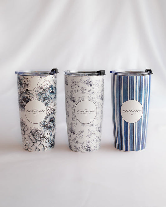 Stainless steel tumblers with floral, toile, and striped patterns in blue and white, featuring the round “Maman” logo.