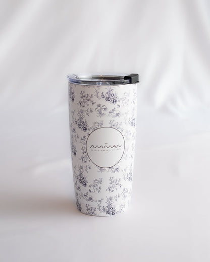 Stainless steel tumblers with a blue-and-white floral toile pattern, featuring the round “Maman” logo.